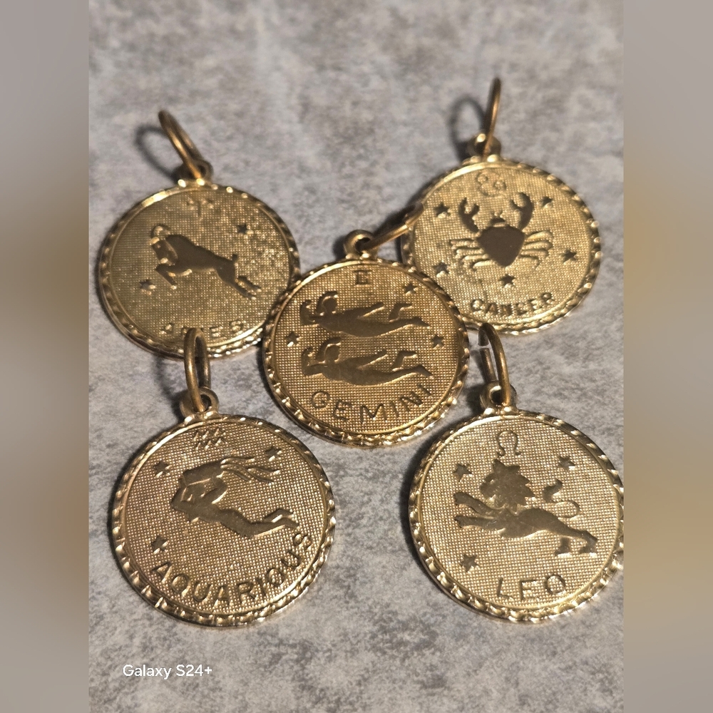 Set of zodiac pendant charms featuring Leo, Gemini, Cancer, and Aquarius